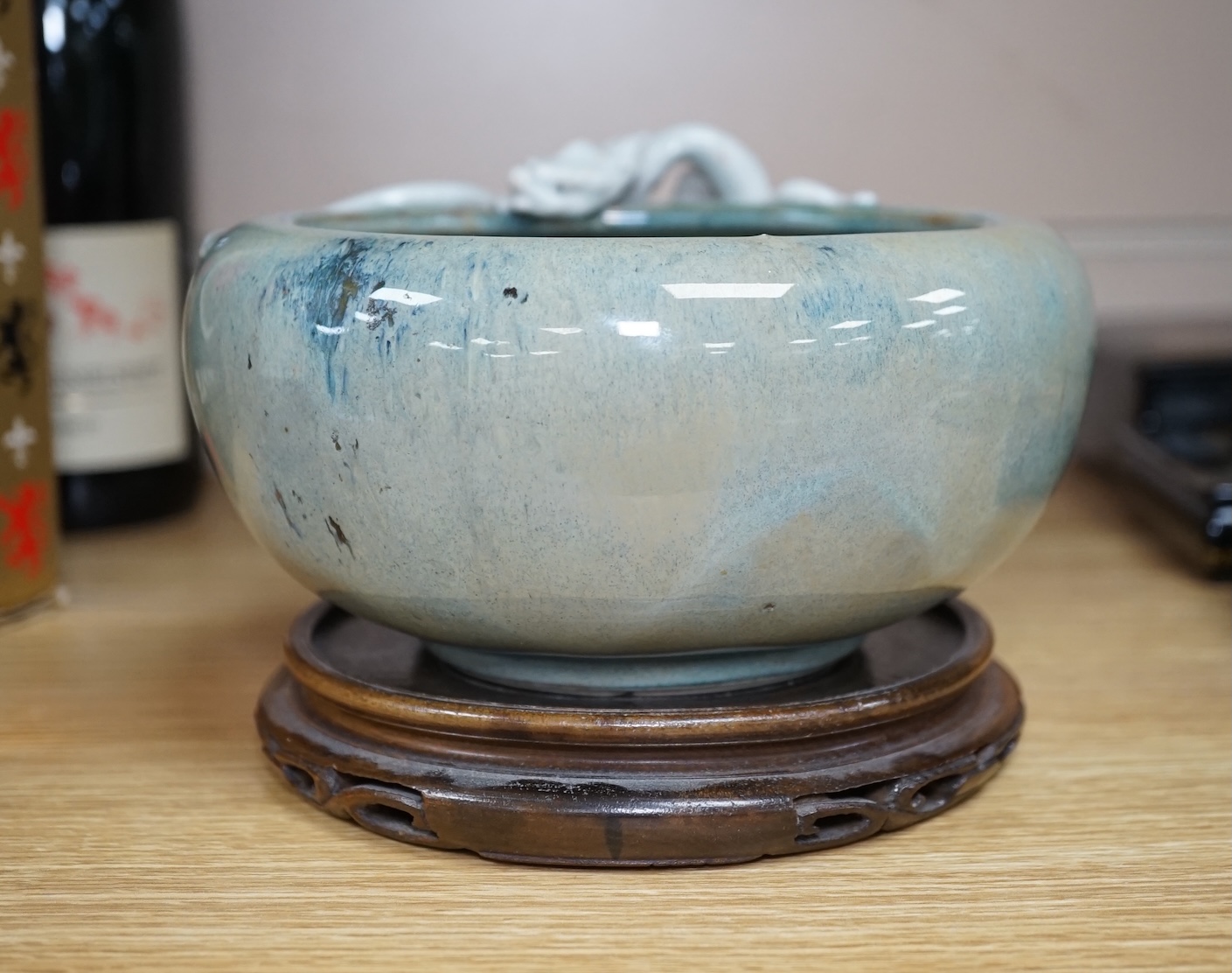 A Japanese Sumidagawa ware ‘dragon’ bowl, Meiji period, signed Ishiguro Koko, wood stand. Condition - scratching and crazing to the glaze on the interior otherwise good.